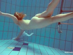 DustyPorn presents: Redhead goes for a nude swim in the pool